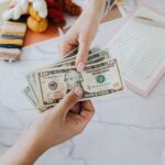 hands exchanging dollars